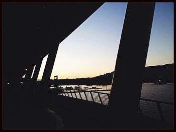 Bridge over river at sunset