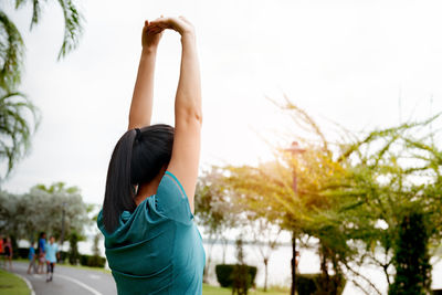 Fitness woman runner stretching arm before run. outdoor exercise