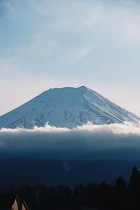 Scenic view of snow covered mountains against sky