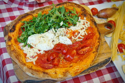 High angle view of pizza served on table