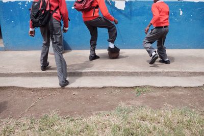 Low section of schoolboys playing football