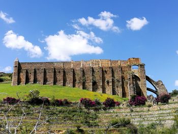 Low angle view of old ruins against sky