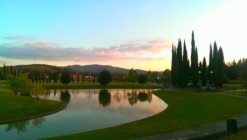 Scenic view of lake against sky at sunset