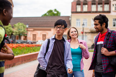 Portrait of friends standing on street