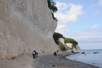 People on beach against sky