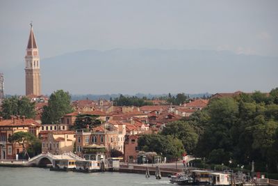 High angle view of buildings by canal against sky in city