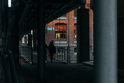 Man standing by building in city