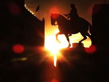 Silhouette man against orange sky during sunset