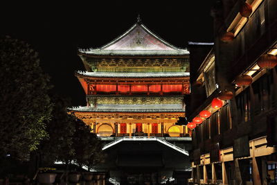 Low angle view of illuminated building at night