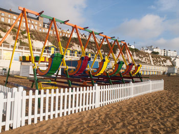 Multi colored umbrellas on beach against sky