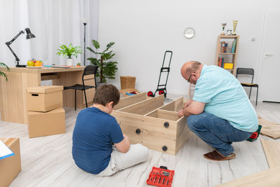 Rear view of man working at home