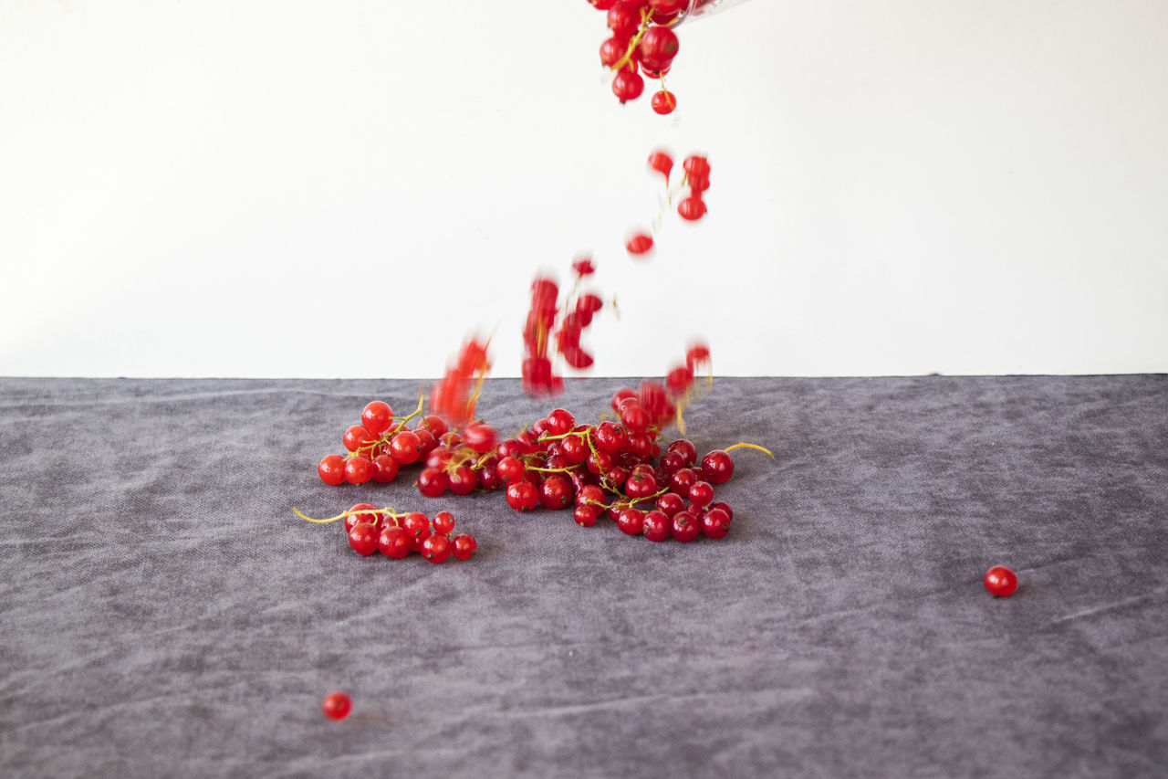 CLOSE-UP OF RED CHERRIES ON TABLE