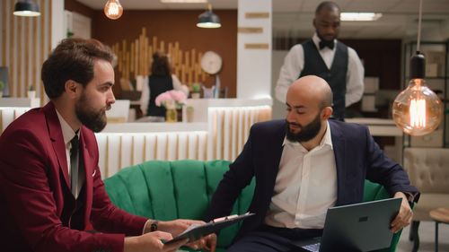 Side view of man using digital tablet while standing in office