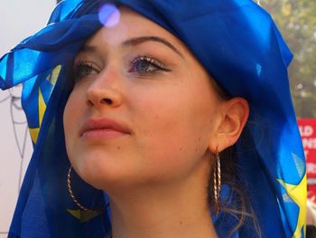 Close-up portrait of young woman looking away