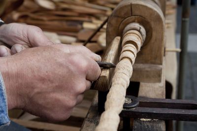 Midsection of man working on wood