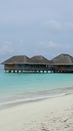 Scenic view of beach by sea against sky