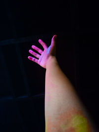 Close-up of person hand over black background
