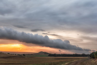 Scenic view of field against sky during sunset