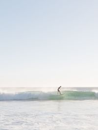 Man on beach against clear sky