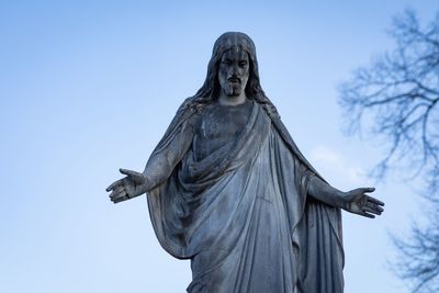 Low angle view of statue against blue sky