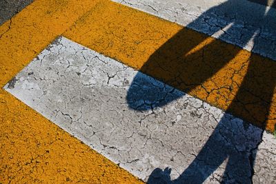 High angle view of shadow falling on road