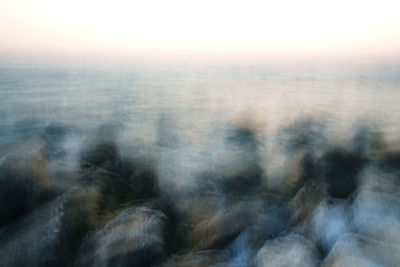 Close-up of snow against sky during sunset