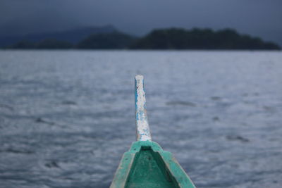 Close-up of boat on sea against sky