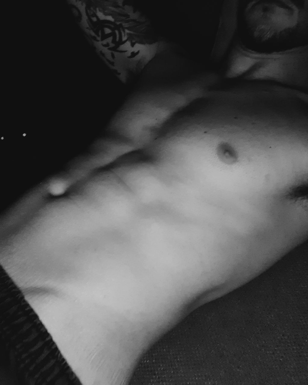 MIDSECTION OF SHIRTLESS LYING ON BED