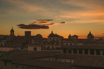 Buildings in city during sunset