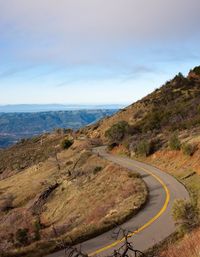 Scenic view of mountain by sea against sky