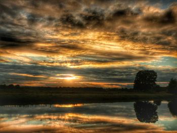 Scenic view of calm lake at sunset