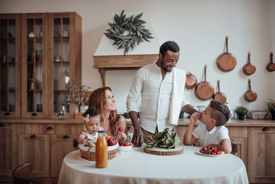 Full length of father and daughter on table