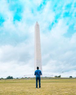 Full length of man standing on field against sky