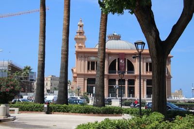 Buildings in city against clear sky