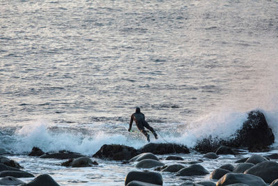 Rear view of surfer in norway