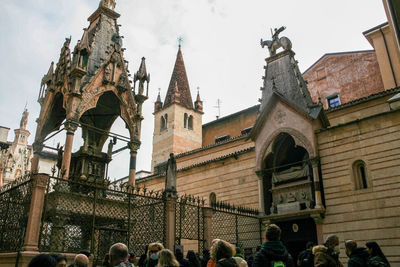 Group of people in front of building against sky