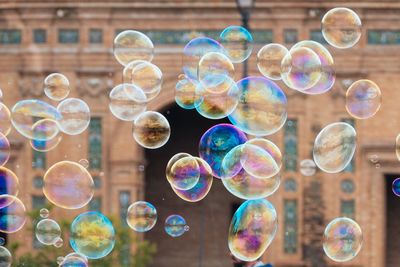 Close-up of bubbles against building in city