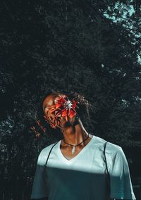 Portrait of man standing against plants