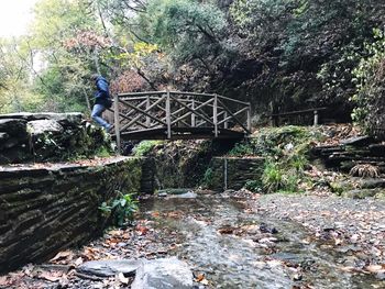 Man walking on footbridge