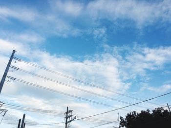 Low angle view of birds flying against sky