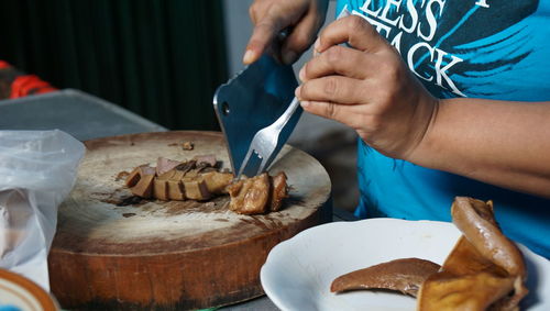 Midsection of man preparing food