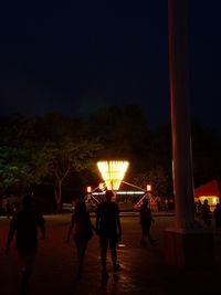 Silhouette of woman in park at night