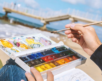 Cropped image of woman painting outdoors