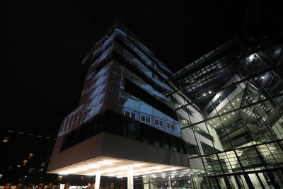 Low angle view of illuminated building against sky at night