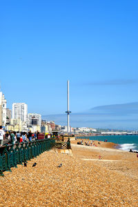 Scenic view of beach against clear blue sky