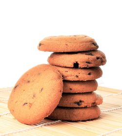 Close-up of stack on table against white background