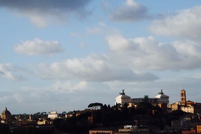 High section of buildings against cloudy sky