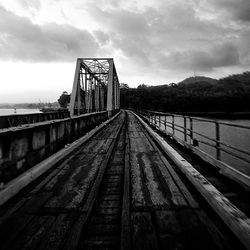 Railroad track against cloudy sky