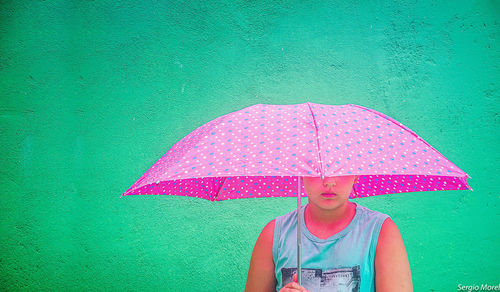 Portrait of man holding umbrella