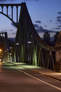 Bridge over road against sky in city